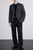 Model wearing Exibit men’s checked blazer styled with knitwear