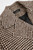 Detailed view of the houndstooth wool blend fabric highlighting the fine brown and beige pattern and soft tactile finish.