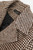 Detailed view of the houndstooth wool blend fabric highlighting the fine brown and beige pattern and soft tactile finish.