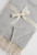 Light grey cotton‑blend throw closeup.