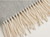 Light grey cotton‑blend throw closeup.