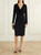 Model wearing Versace Jeans black long sleeve dress, showing the fitted long‑sleeve design and clean, elegant shape.