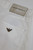 Close‑up of denim texture, stitching, or branding on the Emporio Armani white jeans.