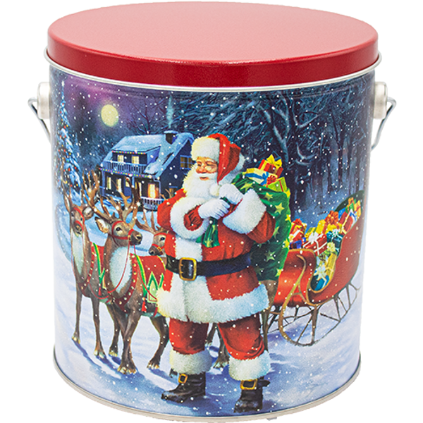 Santa with Reindeer Classic Popcorn Tin – 1 Gallon — Santa standing beside his sleigh and reindeer under a snowy night sky.