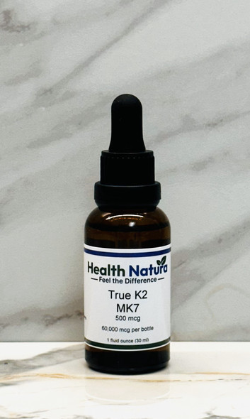 True K2 Mk7 1 ounce supplement bottle with 500mcg vitamin on white marble.