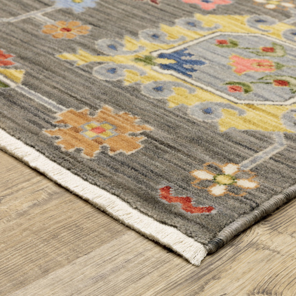 8' X 11' Grey Charcoal Yellow Blue Rust Red Pink Green And Ivory Oriental Power Loom Stain Resistant Area Rug With Fringe