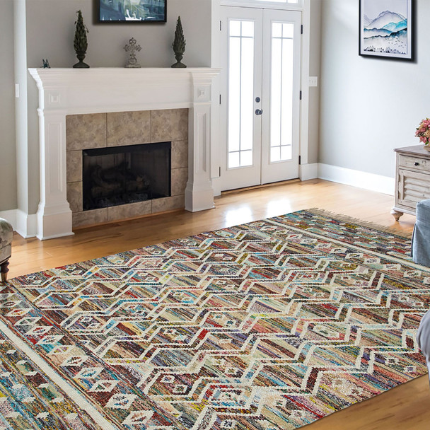 5' X 8' Ivory Blue Pink Gold And Green Geometric Hand Woven Area Rug With Fringe