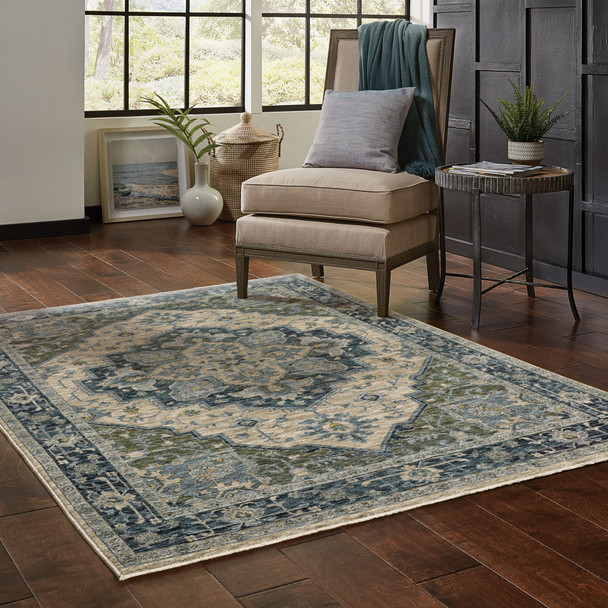 10' X 13' Blue Grey Beige Tan Green And Gold Oriental Power Loom Stain Resistant Area Rug With Fringe