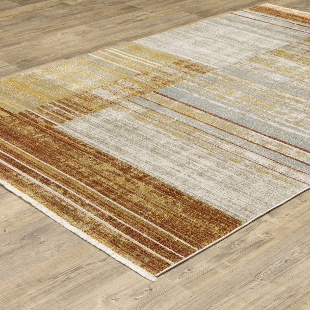10' X 13' Rust Gold Blue Grey Ivory And Tan Geometric Power Loom Stain Resistant Area Rug With Fringe