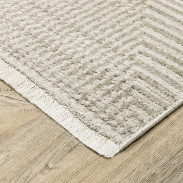 10' X 13' Ivory Beige Taupe And Tan Geometric Power Loom Stain Resistant Area Rug With Fringe