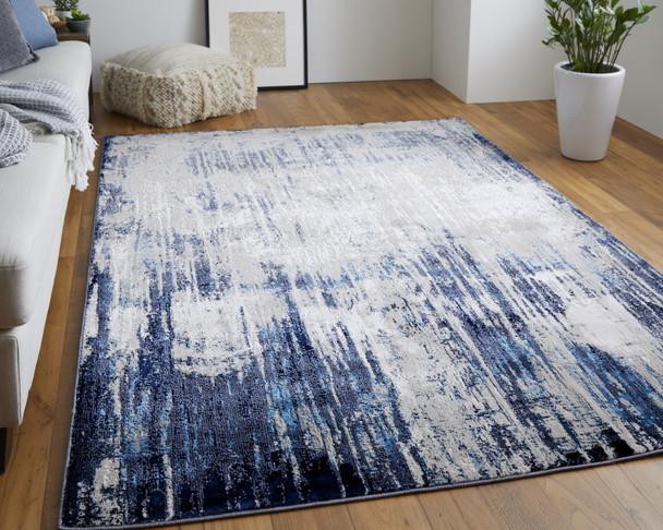 9' X 12' Tan Blue And Ivory Abstract Power Loom Distressed Area Rug