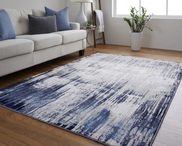 10' X 13' Tan Blue And Ivory Abstract Power Loom Distressed Area Rug