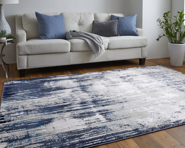 10' X 13' Tan Blue And Ivory Abstract Power Loom Distressed Area Rug