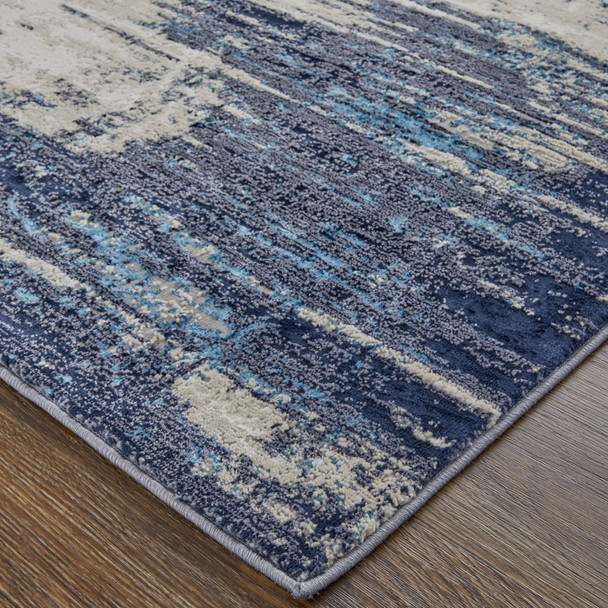 10' X 13' Tan Blue And Ivory Abstract Power Loom Distressed Area Rug
