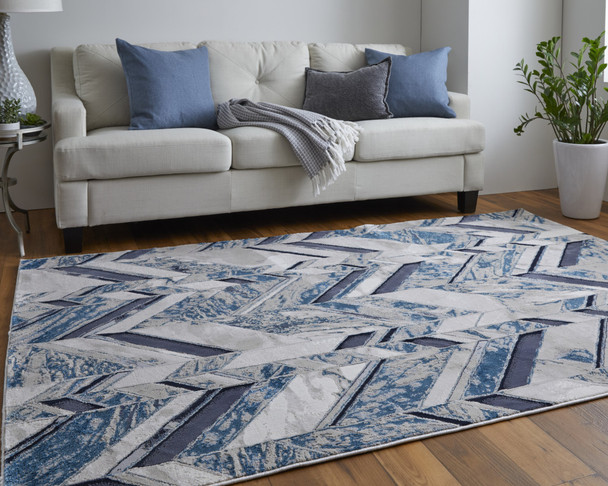 10' X 13' Ivory Blue And Gray Chevron Power Loom Distressed Area Rug