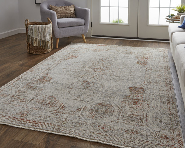 10' X 13' Tan Ivory And Orange Floral Power Loom Distressed Area Rug With Fringe
