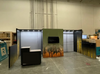 10x20 booth with 10x20 with side returns, dressing room, headers with lights, product hanging rods shelving, TV, lit logo.