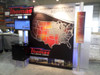 Custom Metalli Piatto Tradeshow Booth with Free-Standing Kiosks and Mounted TVs