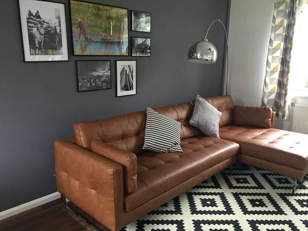 brown leather sofa gray walls white carpet