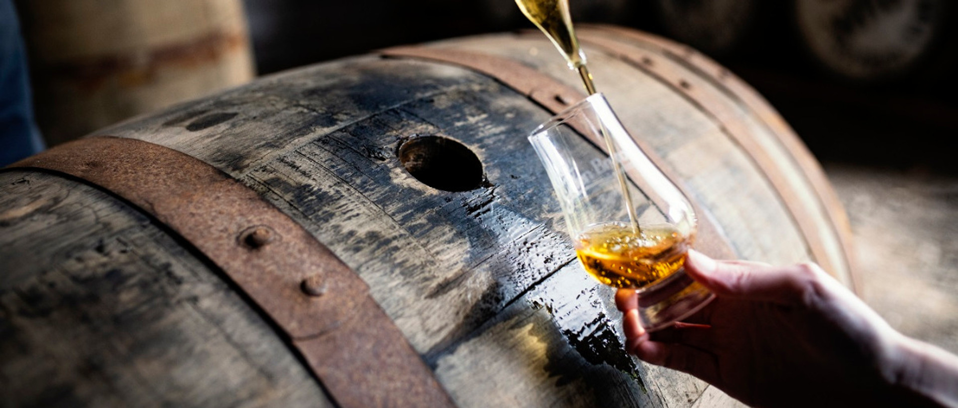 Taking sample of Glen Breton Whisky from barrel