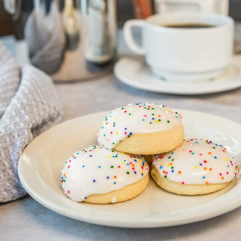 Rosette Cookies – Soft Italian Cookies with Fondant Icing & Rainbow Sprinkles (10-Pack)

Taste the cookie that made Villa Italia Bakery famous. Our Rosette Cookies are soft, citrus-kissed Italian cookies topped with a smooth, sweet fondant icing and colorful rainbow sprinkles. Baked fresh and packed with care, this 10-pack features our best-selling cookie—beloved in New York’s Capital Region for nearly 60 years.

Perfect for parties, holidays, birthdays, corporate gifts, or everyday snacking, these iconic Italian bakery cookies stay soft and flavorful for days and ship beautifully nationwide.