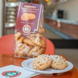Shop Villa Italia’s classic Italian pignoli cookies. Made with almond paste, covered in pine nuts, and baked until golden. Soft and chewy in a 9 oz bag.