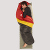 Sierra Designs Nitro 20 sleeping bag, red/black with yellow stripe, front view, partially opened, with man sleeping on his side