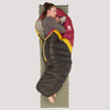 Sierra Designs Women's Nitro 20 sleeping bag, purple/black with yellow stripe, front view, partially opened, with woman sleeping on her side