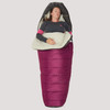 Woman sleeping in Sierra Designs Women's Synthesis 20 sleeping bag, with bag partially unzipped