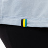 Close up of woman wearing Sierra Designs Women's Alpine Start Sun Tee, showing SD tricolor tag