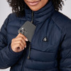 Close up of woman wearing Sierra Designs Women's Sierra Down Jacket, putting phone in pocket