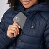 Close up of woman wearing Sierra Designs Women's Whitney Down Hoodie, putting phone in pocket