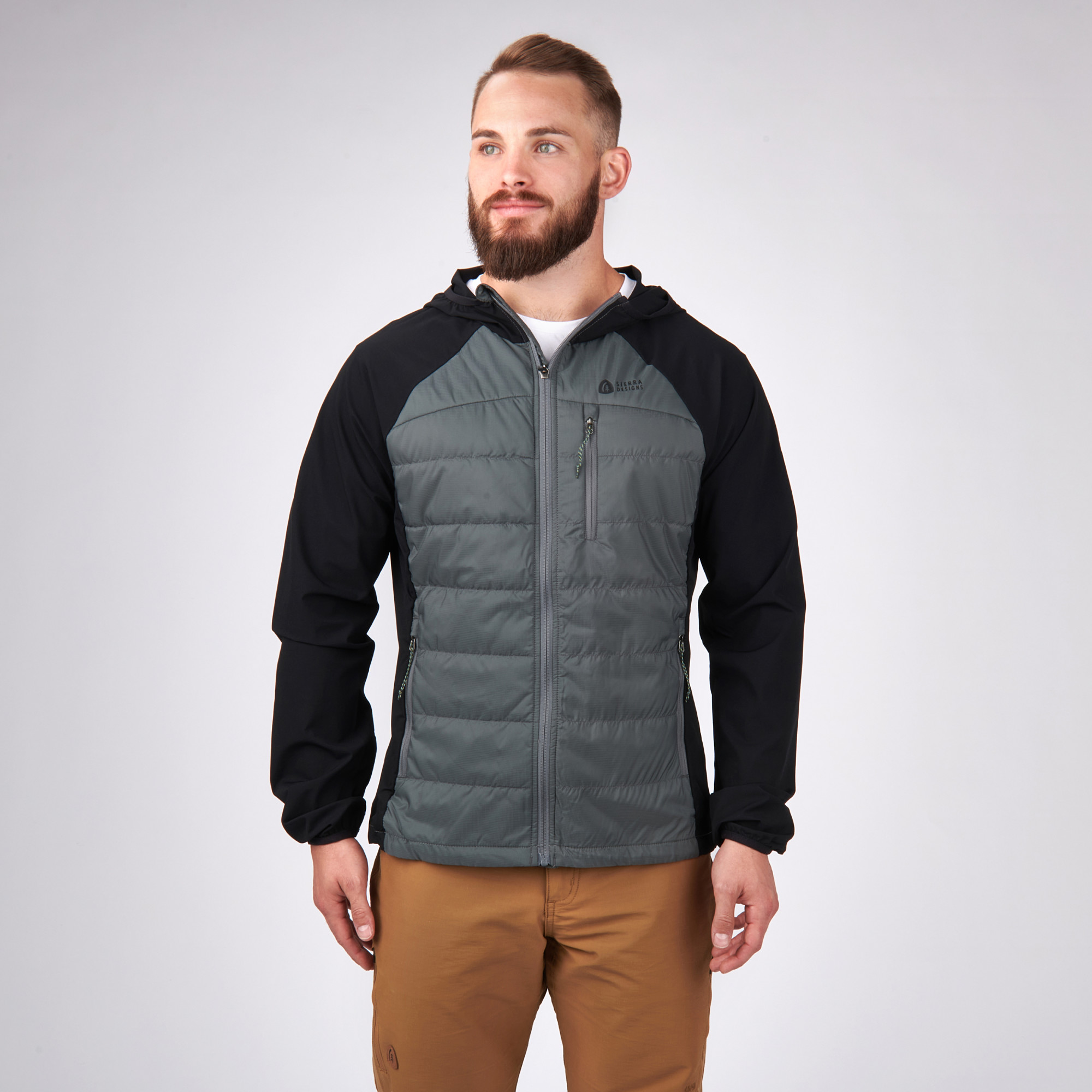 Man wearing Sierra Designs Men's Borrego Hybrid Jacket, Black/Grey, front view