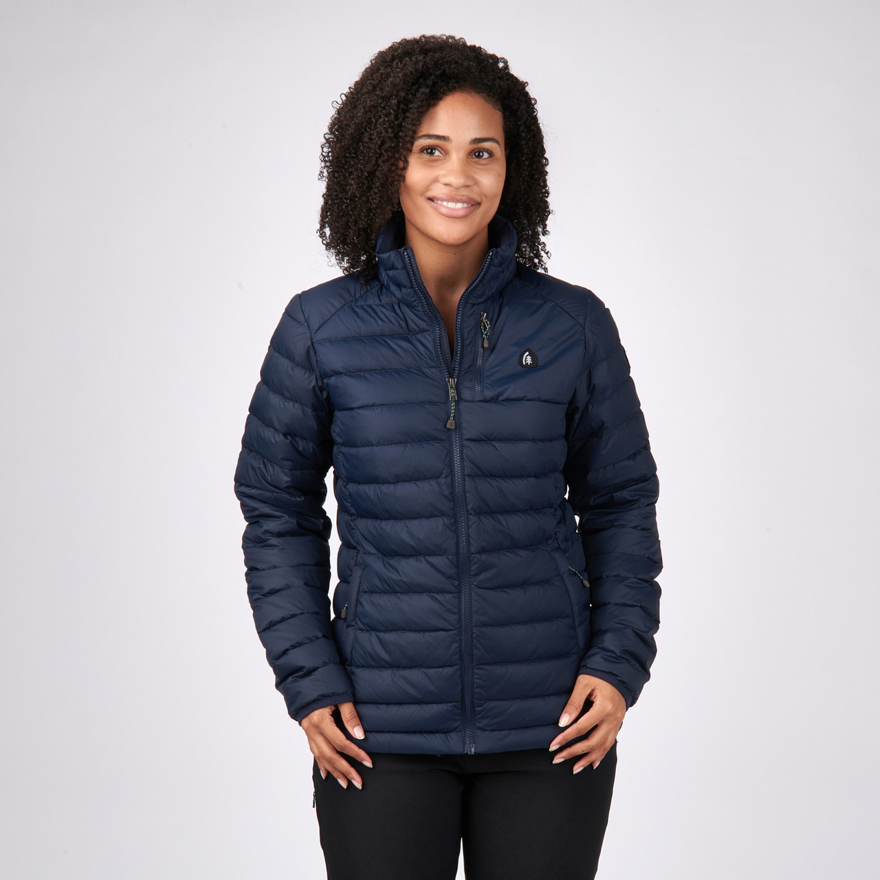 Woman wearing Sierra Designs Women's Sierra Down Jacket, Midnight Navy, front view