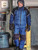 Black/Blue-Man standing by a loading dock wearing Frostline® Bib Overalls