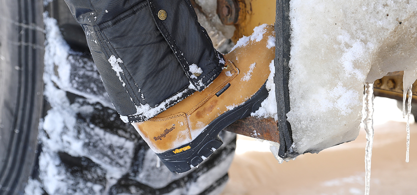 Man wears durable winter work boots in the snow.