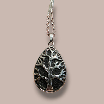 Spoil your Senses and Body as they receive essential oil essences from your own Tree of Life Lava Necklace. Black Volcanic Rock cooled, dried has bubbles throughout, as a result will hold onto Essential Oils that are added to the back of the pendant. Diffusing feelings of therapeutic relaxation.

Add one of our "Crystal Oil Rollers" to your Order so you can Get Started Right Away  Note: Lava has its own grounding and healing properties you may like to see our Lava Aromtherapy Bracelet for properties information. You may choose to leave the pendant Oil Free.