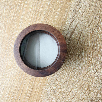 Natural dark wood Ring Box is 50mm Round and stands 34mm tall, featuring a clear see through top panel. Soft inner ring material to slide in your precious jewellery. If you are gifting a ring this box is exciting and perfect for creating pre opening suspense whether for a wedding, engagement, birthday, anniversary or any other celebration.