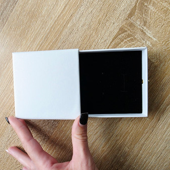 Pearl shimmer Jewllery Gift Box pulls out towards you, revealing your jewellery in a perfectly set velvet soft black foam. This jewellery box can sit a necklace, earrings and ring, or you may choose to use it for only one peice of jewellery. This box can be used for weddings, anniversarys, birthdays, religous ceremonies and celebrations, Valentine's day gifting and more. The closed Pearl Jewellery Box measures L100mm x W110mm with gold knob, H35mm.