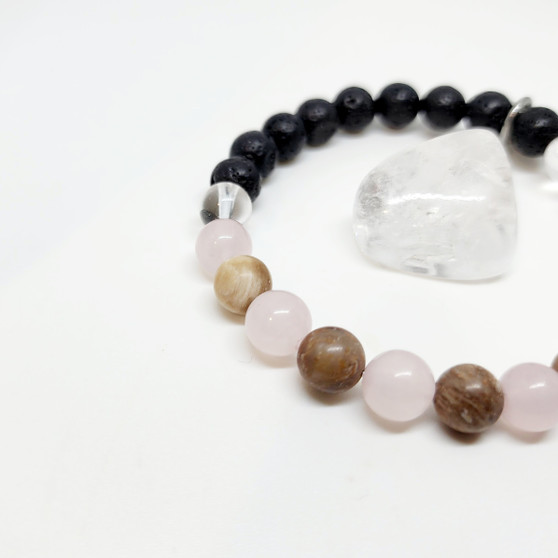 The "Amy" Bracelet was designed by, yup you guessed it, our very own Boss Lady, Amy! Featuring Petrified Wood and Madagascan Rose Quartz for a powerhouse of loving, positive energy. A transformational bracelet that encourages grounding in the self with the utmost trust, harmony and hope for connecting and strengthening family bonds, including those past. Rose Quartz is your go to for deepening self love and healing the heart, while creating peace and calm in an otherwise abusive or depressive space. Working with your energy to overcome any depression source and reminding you to accept the past and forgive your own mistakes. Petrified Wood can assist in connecting with your spiritual guardians for that extra bit of guidance in times of need. Remember to add oils to your volcanic rock beads to enhance your wearing experience.

Chakra: Root + Heart

Oil Roller: 3% Rose Oil with Rose Quartz