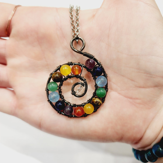 Chakra beads bound in antique copper wire spiral to provoke energy movement for healing. 70cm Surgical Grade Stainless Steel Chain.