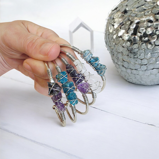 Beautifully simplistic Silver Plated Bangle that adjusts outwards for larger wrists. Each stone, a piece of natural rarity, unpolished crystal. Sharing its raw beauty, undeterred by anyone or anything, just existing. They offer the wearer their known Vibrational Energy to share so the mind body and soul can align more closely with their intended purpose. 

Available in:

Green Aventurine WELLBEING + LOVE

Blue Apatite SPIRITUAL GROWTH

Amethyst INTUITION + CALM

Clear Quartz CLARITY + FOCUS