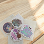 10 Pack of Crystal Stickers, White Border and backing. Stick to any surface, laptops, phones, books, interiors. These mixed variety stickers are approx 5-6cm. These make a very CUTE ADD ON to any special purchase!