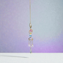 A delicate and delightful addition to calm any space. This Suncatcher is made with an Amethyst Tree of Life dangling between a Crescent Moon and Saturn Planet, electroplated glass Gems, Stars and Points to catch and refract light from the sun. Amethyst is calming for the mind and body, for soft peaceful sleep, and enhanced intuition