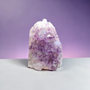 Quality Brazilian Amethyst Large point, upright cluster that features a breathtaking amount of quartz developed behind its purple teeth ? Polished and rounded outer edges with minimal raw rock behind. Majority of weight is high quality Amethyst to Calm your mind and soothe the soul into a more relaxed state - lets be real - your not coping or sleeping - so pick yourself up, buy Amethyst, focus on being relaxed for a short while and proceed at life once more ?❤️