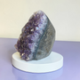 This Quality Brazillian Amethyst Cluster stands alone, weighing 366grams this purple Amethyst beauty has been preserved with as much as 7cm of supporting rock. This Amethyst Cluster has deep indigo purples within centre and bright rainbow violets towards her outer edges. Adopt this 8cm high Amethyst and enjoy the calming and healing properties of Amethyst at home.
Amethyst Properties
Clear your mind & relax with clarity. Amethyst is often worn when one seeks to find intuition in life, clarity about decisions & direction with divine communications. Widely known as good for headaches, the calming vibrational energy flows with you, encouraging peaceful sleep. It's deep indigo purple colour is one that you can easily get lost in, especially good for any fear of the dark. Amethyst's tranquil energy can be most beneficial to those with Obsessive Compulsive Disorder. Amethyst may bring a little inner calm to hyperactive children. It is also found helpful in bringing a gentle sense of comfort for thoughts when worn everyday. Amethyst is the Birthstone fro February. Cleanse and set your intentions before you wear. Amethyst aligns with the Third Eye Chakra. Amethyst closely aligns to the personality traits of Aquarius. Compliment your crystals with our Lavender Oil Roller with Amethyst Shaker Stones. Roll onto black volcanic rock beads for aromatherapy benefits. Also search Amethyst Ring.