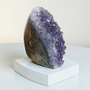 This Quality Brazillian Amethyst Cluster stands alone, weighing 366grams this purple Amethyst beauty has been preserved with as much as 7cm of supporting rock. This Amethyst Cluster has deep indigo purples within centre and bright rainbow violets towards her outer edges. Adopt this 8cm high Amethyst and enjoy the calming and healing properties of Amethyst at home.
Amethyst Properties
Clear your mind & relax with clarity. Amethyst is often worn when one seeks to find intuition in life, clarity about decisions & direction with divine communications. Widely known as good for headaches, the calming vibrational energy flows with you, encouraging peaceful sleep. It's deep indigo purple colour is one that you can easily get lost in, especially good for any fear of the dark. Amethyst's tranquil energy can be most beneficial to those with Obsessive Compulsive Disorder. Amethyst may bring a little inner calm to hyperactive children. It is also found helpful in bringing a gentle sense of comfort for thoughts when worn everyday. Amethyst is the Birthstone fro February. Cleanse and set your intentions before you wear. Amethyst aligns with the Third Eye Chakra. Amethyst closely aligns to the personality traits of Aquarius. Compliment your crystals with our Lavender Oil Roller with Amethyst Shaker Stones. Roll onto black volcanic rock beads for aromatherapy benefits. Also search Amethyst Ring.
