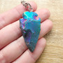 Rainbow Agate cut into a Spearhead and set on a steel 70cm necklace chain.

Agate is an excellent stone for creating harmony + balance within the mind, body + spirit.  Agate is known to cleanse + stabilises the aura, decreasing negativity.  Agate enhances mental function, improving concentration, perception and analytical abilities.  Providing a soothing, calm energy for healing inner anger or tension and creating a sense of security and safety. Agate heals the eyes, stomach and uterus; cleanses the lymphatic system and the pancreas; strengthens blood vessels and heals skin disorders.

Rainbow effect is from elecroplating.