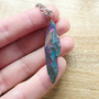 Rainbow Agate cut into a Spearhead and set on a steel 70cm necklace chain.

Agate is an excellent stone for creating harmony + balance within the mind, body + spirit.  Agate is known to cleanse + stabilises the aura, decreasing negativity.  Agate enhances mental function, improving concentration, perception and analytical abilities.  Providing a soothing, calm energy for healing inner anger or tension and creating a sense of security and safety. Agate heals the eyes, stomach and uterus; cleanses the lymphatic system and the pancreas; strengthens blood vessels and heals skin disorders.

Rainbow effect is from elecroplating.