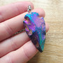 Rainbow Agate cut into a Spearhead and set on a steel 70cm necklace chain.

Agate is an excellent stone for creating harmony + balance within the mind, body + spirit.  Agate is known to cleanse + stabilises the aura, decreasing negativity.  Agate enhances mental function, improving concentration, perception and analytical abilities.  Providing a soothing, calm energy for healing inner anger or tension and creating a sense of security and safety. Agate heals the eyes, stomach and uterus; cleanses the lymphatic system and the pancreas; strengthens blood vessels and heals skin disorders.

Rainbow effect is from elecroplating.